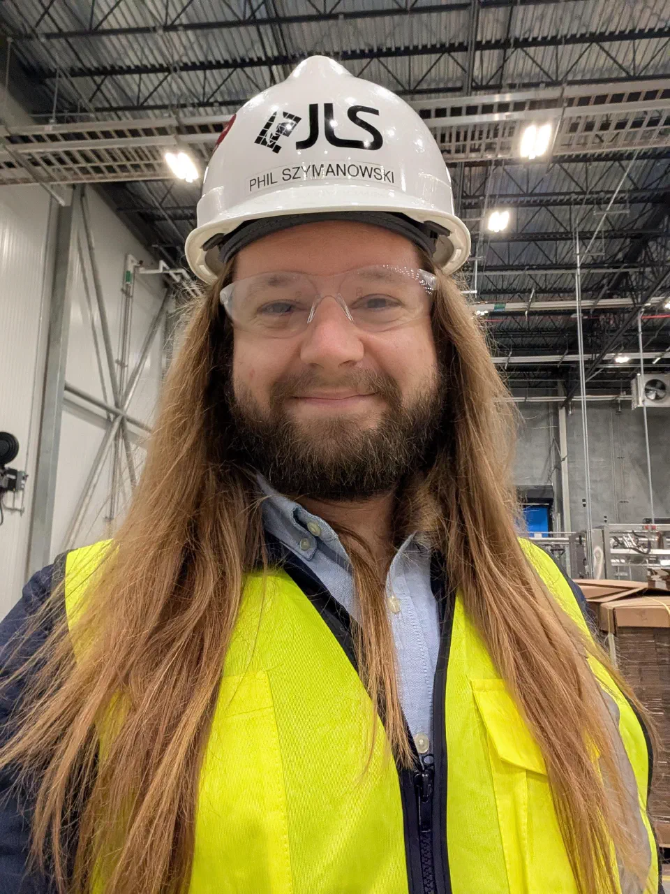 Phil Szymanowski in a JLS Automation hard hat, safety glasses and hi-vis vest