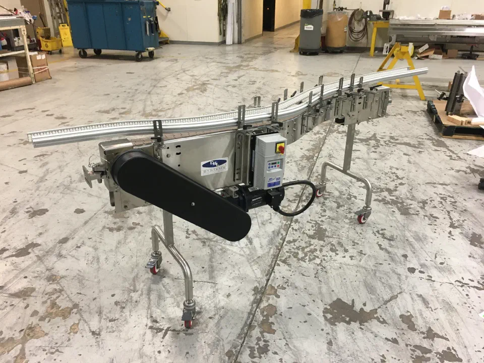 A conveyor section on casters with its drive and control enclosure