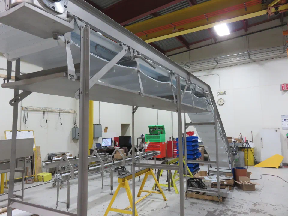 An overhead conveyor run during shop build