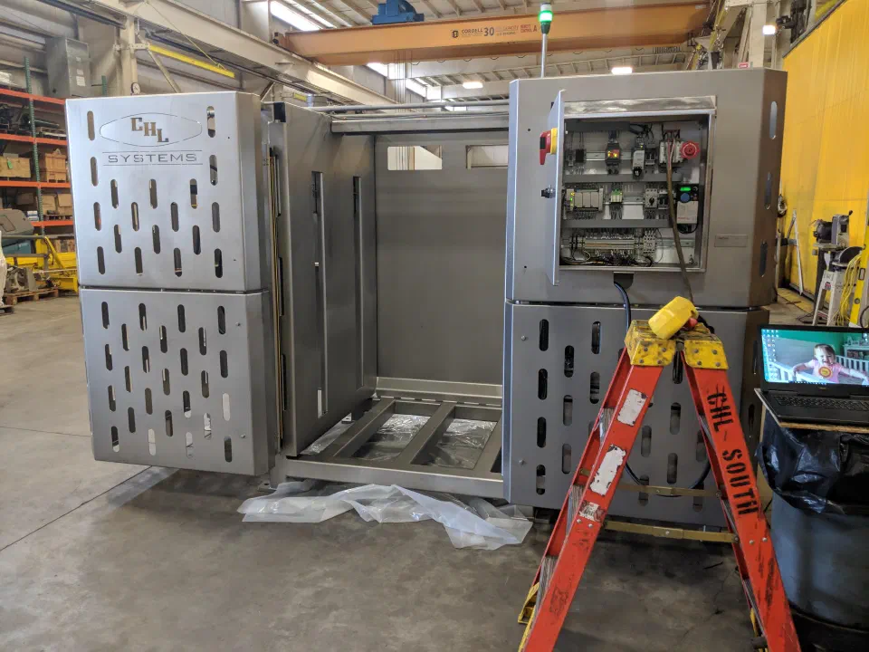 The first machine with its stainless guard panels open