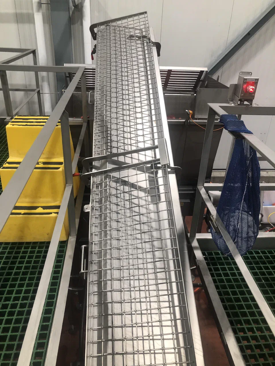 The installed incline auger with mesh guarding