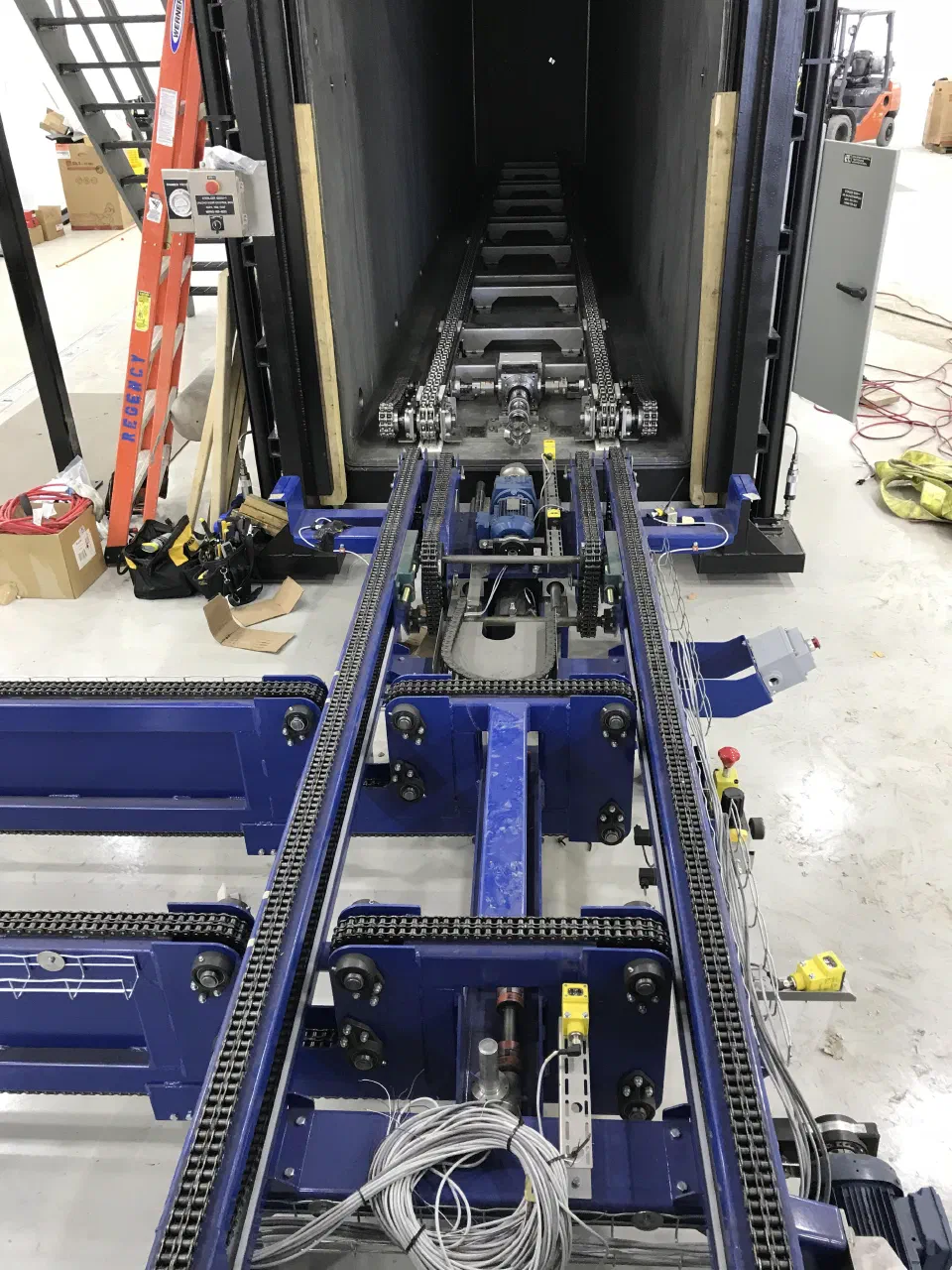 The conveyor running into the sterilizer chamber. Inside the chamber there is no motor, only a gearbox and a coupler