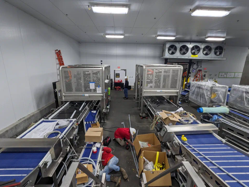 Both cells installed, with conveyors being assembled around them