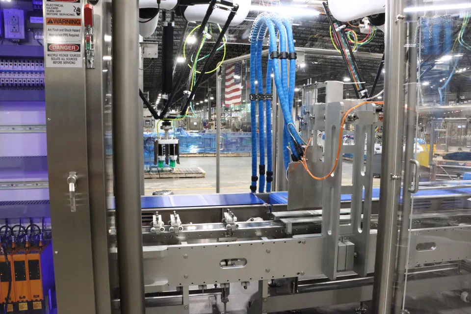 The picker station's robot and product conveyor