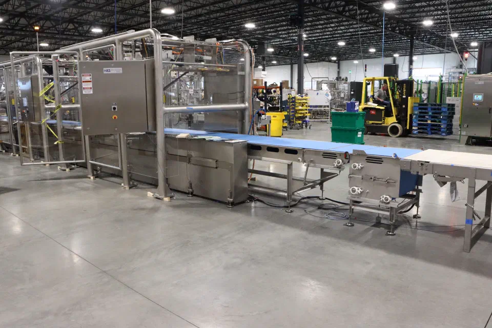 A robot cell frame staged in the shop before shipping