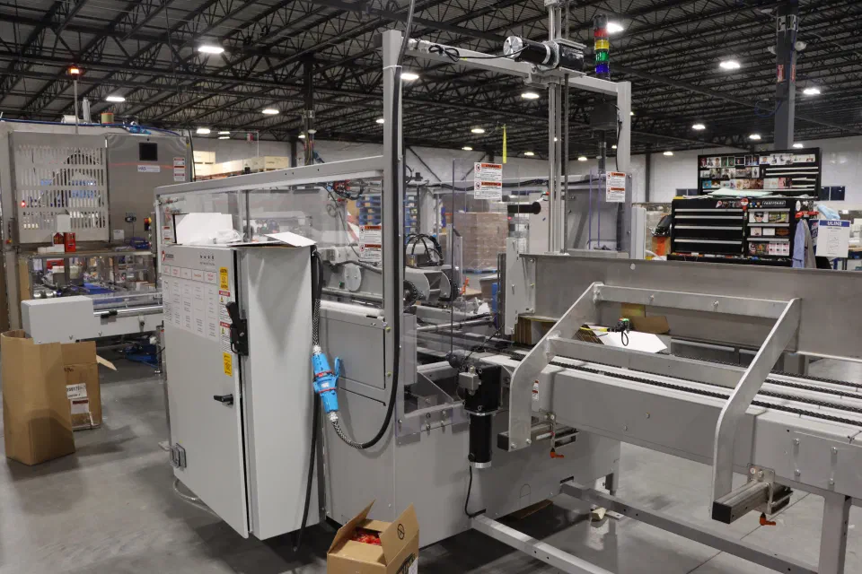 Case erecting and sealing equipment staged for shipping