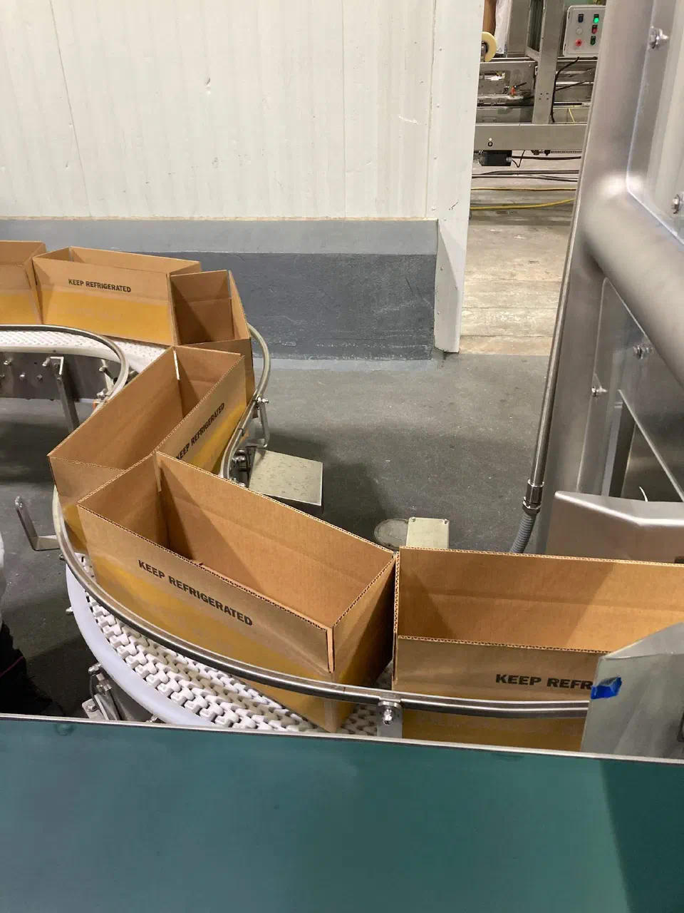 Open cases on the customer's curved case conveyor