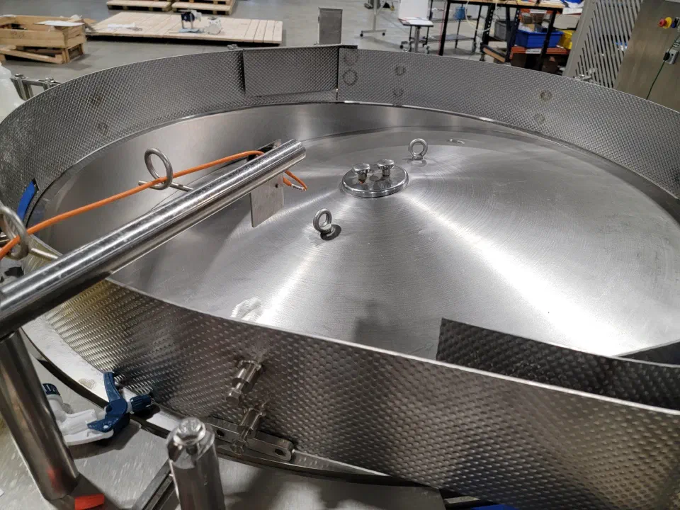 The empty stainless bowl of the feeder