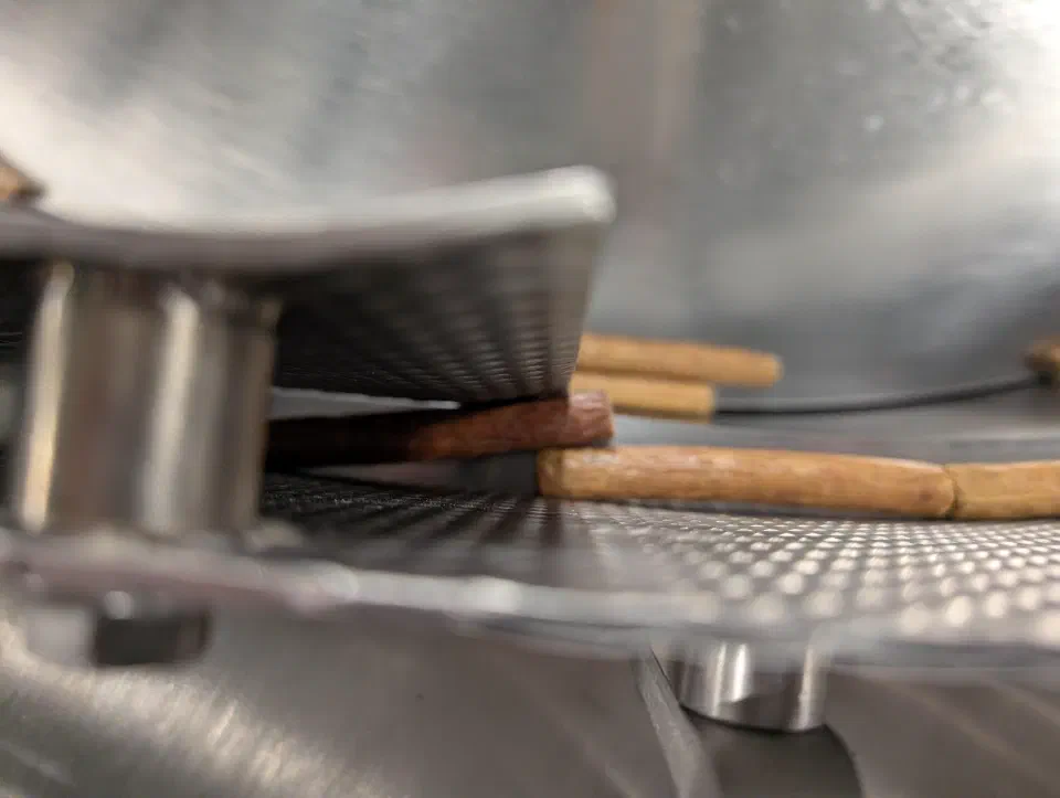 Sticks queued between guide plates on the collation conveyor during testing